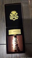 Windsor Eau de Parfum bottle with gold cap and logo, inside black velvet lined box