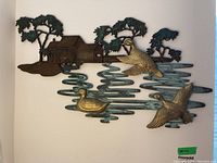 Full view of metal wall art showing mill house, trees, and ducks on water