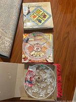 Three serving dishes shown with the Florentine ceramic platter box and two glass serving dishes, one clear with floral motifs on a wooden surface.