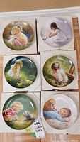 Six Pemberton & Oakes collector plates in box, each depicting children with pets in painted scenes