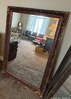 Full view of the large rectangular mirror reflecting the room.