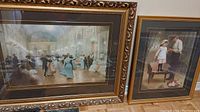 Two framed prints side by side: the larger print titled "Dance Floor" shows ballroom dancing, the smaller shows a young girl on a chair with a man, both in wood frames.