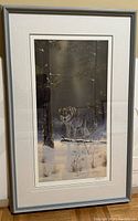 Full view of the framed print 'The Shadow Hunter' showing the wolf in a snowy forest scene, including frame and matting