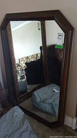 Full front view of the rectangular mirror showing the dark wood frame and reflective glass. Mirror dimensions visible in image are approximately 34 x 49 inches.