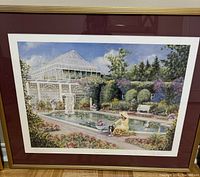 Full view of framed print showing garden scene with woman by pool, statue, and glass conservatory.