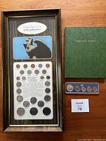 Wooden framed coin collection display alongside a green Lincoln Cents collection book and a 1967 mint set.