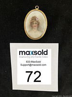 Oval antique brooch/pin with hand-painted ceramic portrait of woman, set in gold frame, photographed with identification number.