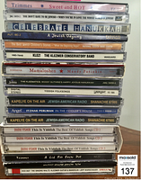 Stack of 18 CDs in jewel cases with titles related to Klezmer, Yiddish songs, and Jewish holiday music.