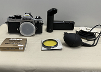 Nikon FM2 body, MD-12 motor drive, 52 mm K2 filter, Type E2 focusing screen in box, pneumatic shutter release cable