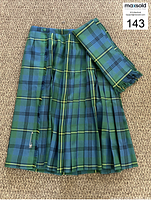 Full view of Scottish tartan kilt and matching sash on carpeted floor