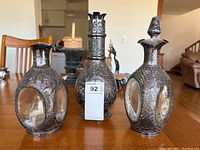 Front view of three decanters on table