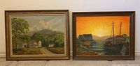 Two framed oil paintings side by side on a beige wall. Left painting shows rural landscape with trees and a house. Right painting shows harbor scene with boats and a sunset.