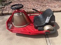 Side view of red Razor Crazy Cart showing frame, seat, steering wheel