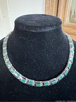 Front view of necklace displayed on black velvet bust