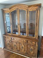 Front view of entire buffet hutch showing glass doors and lower cabinets