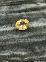 Top view of oval faceted citrine showing color and clarity.