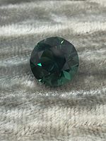 Top view of faceted round emerald showing crown and table facets