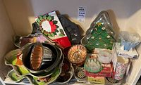 Image showing collection of various holiday-themed bakeware molds including Christmas tree pan, copper fluted pan, assorted shaped molds, and pancake molds.