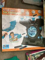 Box of the Hover Shot electronic game showing the launcher and target with foam darts, with a boy playing the game on the box art.