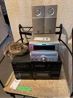 Full view of TEAC MC-D90 CD changer/tuner/amplifier on top of Toshiba stereo amplifier, with Yamaha speakers on top and speaker wire bundled next to the unit.