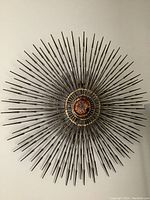 Front view of starburst metal art mounted on wall