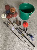 Full overview of fishing rods, balls, tub, baseball equipment, cones and jump ropes