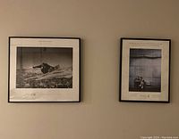 Two black and white framed photographs on a wall showing Olympic athletes.