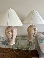 Pair of terra-cotta styled western lamps on glass table showing full size and matching fabric shades.