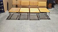 Front view of four chairs in a row on concrete floor