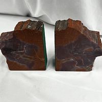 Pair of natural red jasper bookends with rough textured tops and polished flat inner sides, shown on white background.