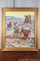 Framed western scene painting showing cowboys on horseback near water and landscape, signed CM Russell 1911.