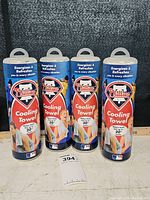 Four Phillies Cooling Towels in original blue cylindrical containers placed upright showing front labels and logos.