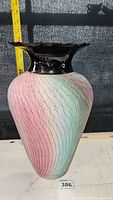 Full view of tall vase showing gradient pastel textured body and glossy black ruffled rim with measuring tape showing approximately 18 inch height.