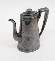 Full view of the silver soldered coffee pot showing side profile with curved spout and squared handle.