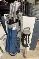 Full view of blue and gray golf bag holding multiple golf clubs and showing original Bag Shag shaft cover.