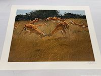 Full view of signed art print showing gazelle herd on the move in golden grass.