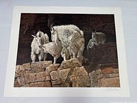 Full view of the framed print showing four mountain goats on rocky cliff edges, signed by Gary Swanson.