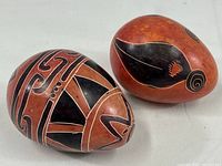 Two hand painted soapstone tribal design eggs from Kenya shown together with their distinct patterns.