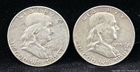 Obverse side of two Franklin Half Dollars showing portraits of Benjamin Franklin dated 1954 and 1959