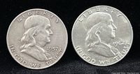 Obverse side of both Franklin Half Dollar coins dated 1957 and 1962, showing Benjamin Franklin's profile and inscriptions.