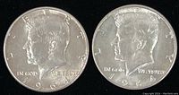 Obverse side of two 1964 Kennedy half dollars showing John F. Kennedy's left profile and the date 1964 without mint marks.