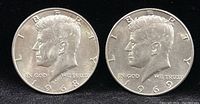 Obverse view of two Kennedy Half Dollar coins from 1959 and 1968.