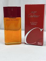 Front view of the perfume bottle alongside its original red box, showing the label and size (100 ml, 3.3 fl. oz)