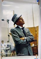 Full view of the Frank Sinatra poster showing Sinatra in a gray suit and hat looking upward. Signed with printed name at the bottom.