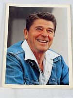 Front side color photo of Ronald Reagan smiling in a denim jacket