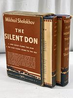 Boxed set of two hardcover novels by Mikhail Sholokhov with visible titles and author name, showing wear on box and dust jackets.