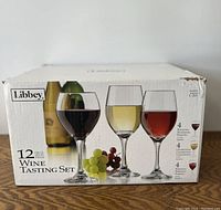 Original box showing set of 12 Libbey wine tasting glasses, with 4 Bordeaux, 4 Chardonnay, and 4 Burgundy glasses pictured.