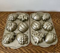 Two Nordic Ware cupcake pans side by side showing all fall themed cupcake molds