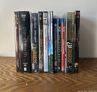 Front view showing all titles standing upright on a wooden surface.