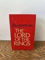 Front view of the red slipcase with gold text 'The Lord of the Rings' and signature.